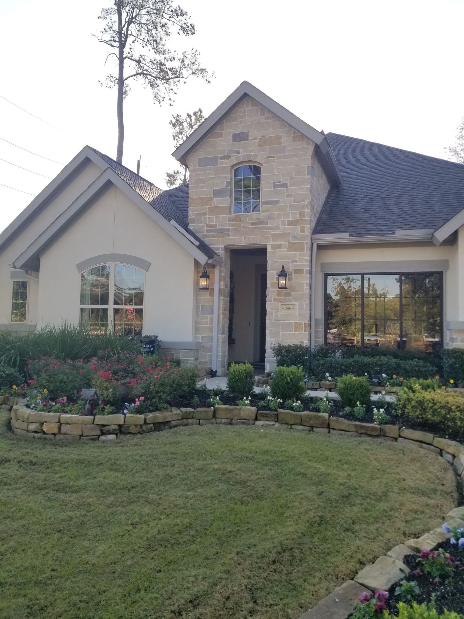 A house with a large lawn in front of it