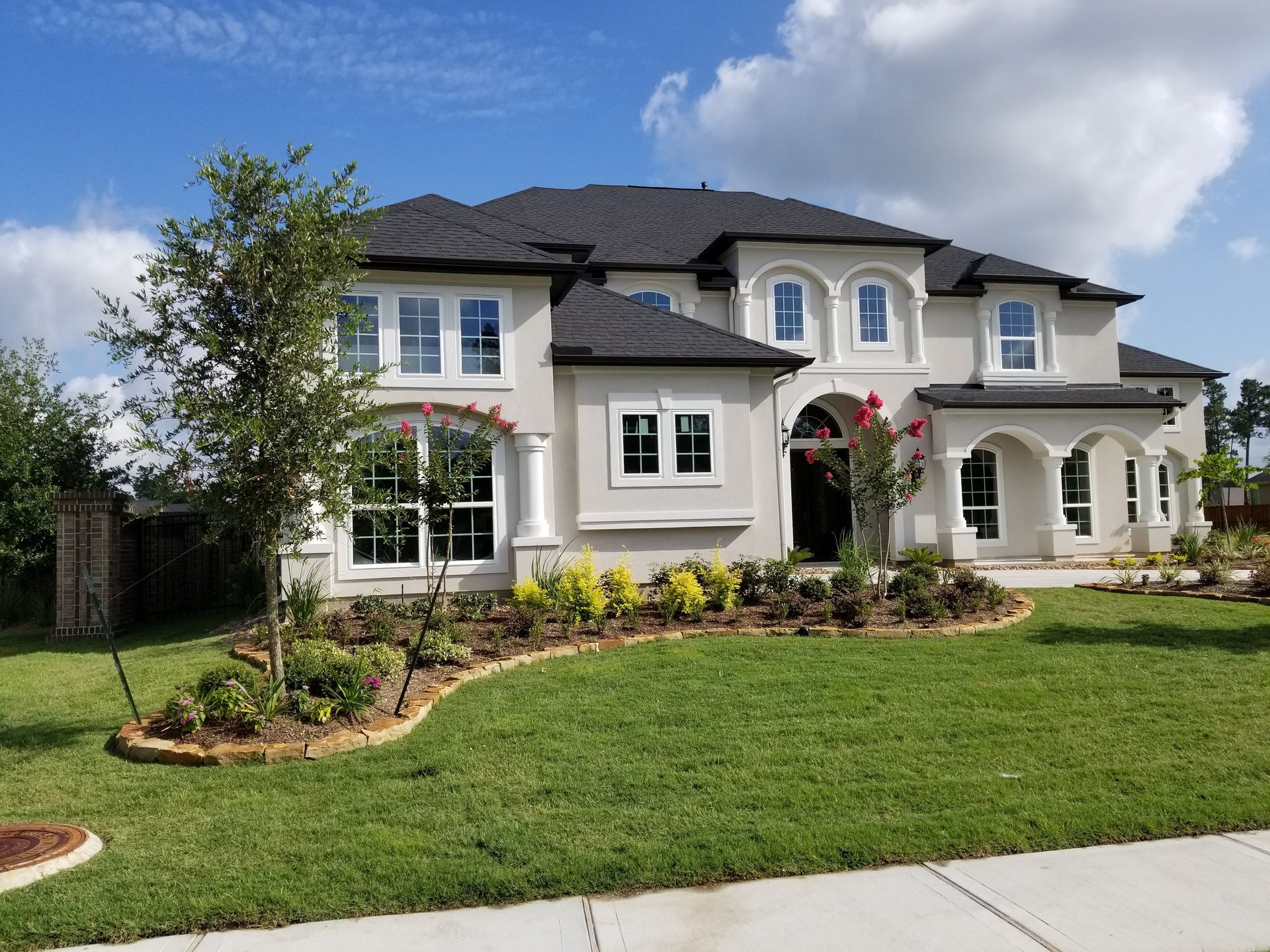 A large white house with a black roof and lots of windows