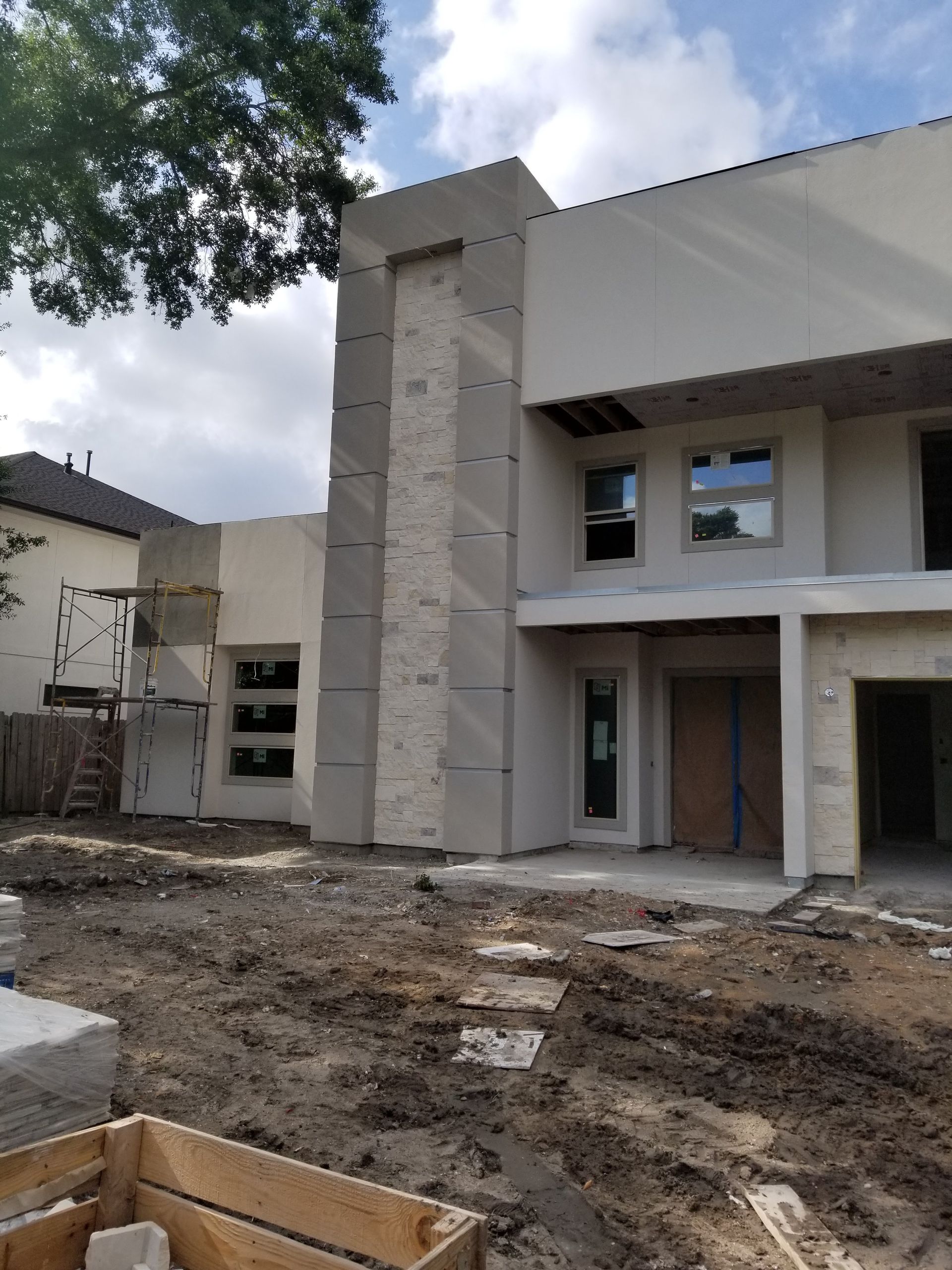 A house is being built with a lot of dirt in front of it