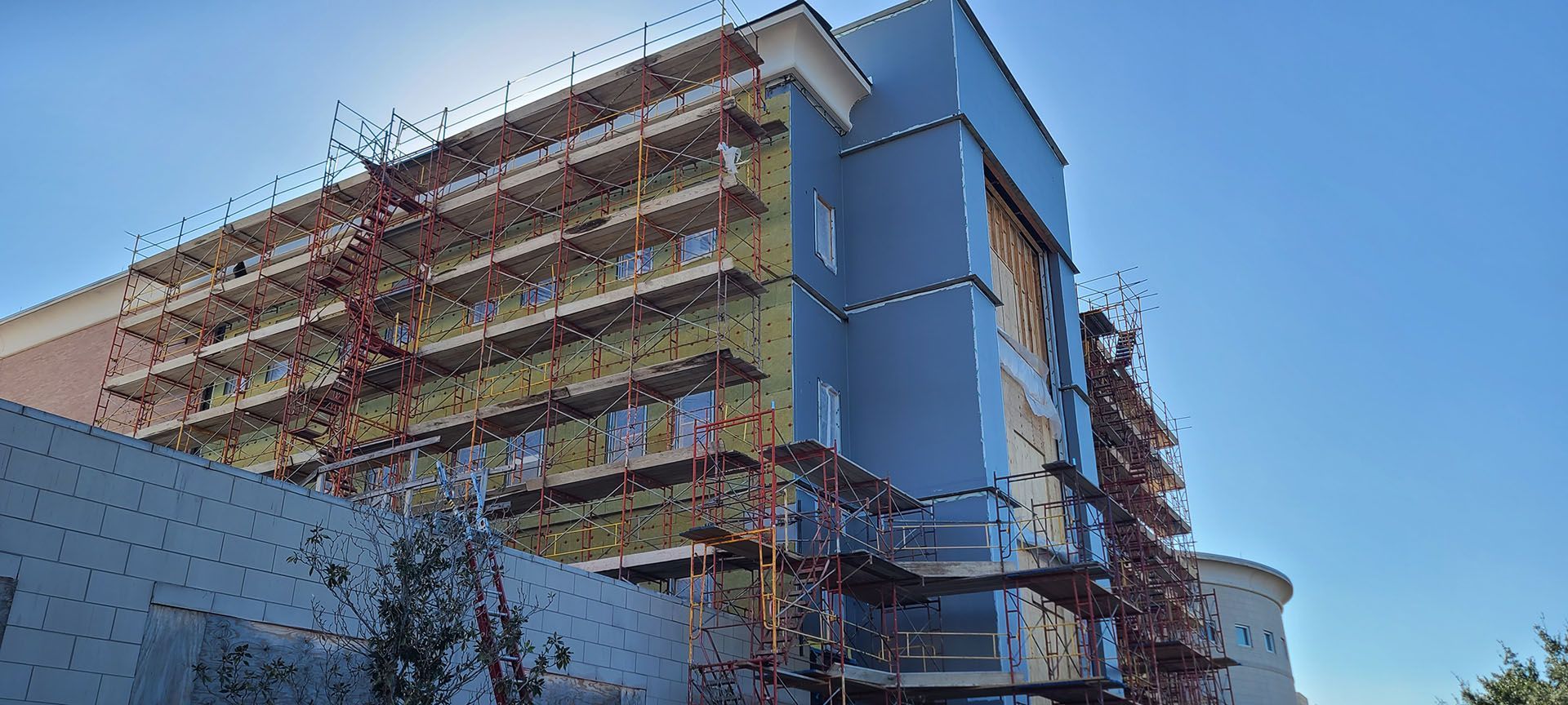 A large building under construction with scaffolding on the side of it.