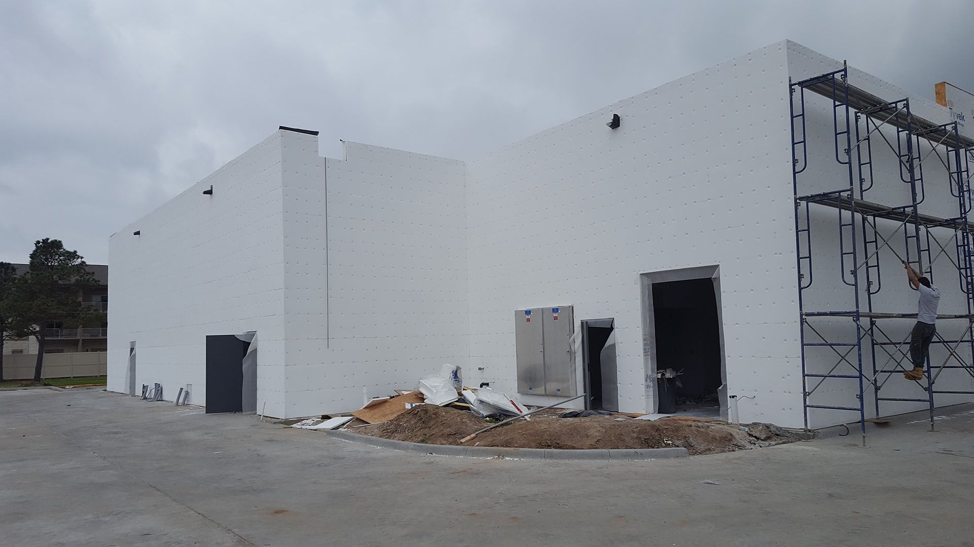 A large white building under construction with scaffolding around it.