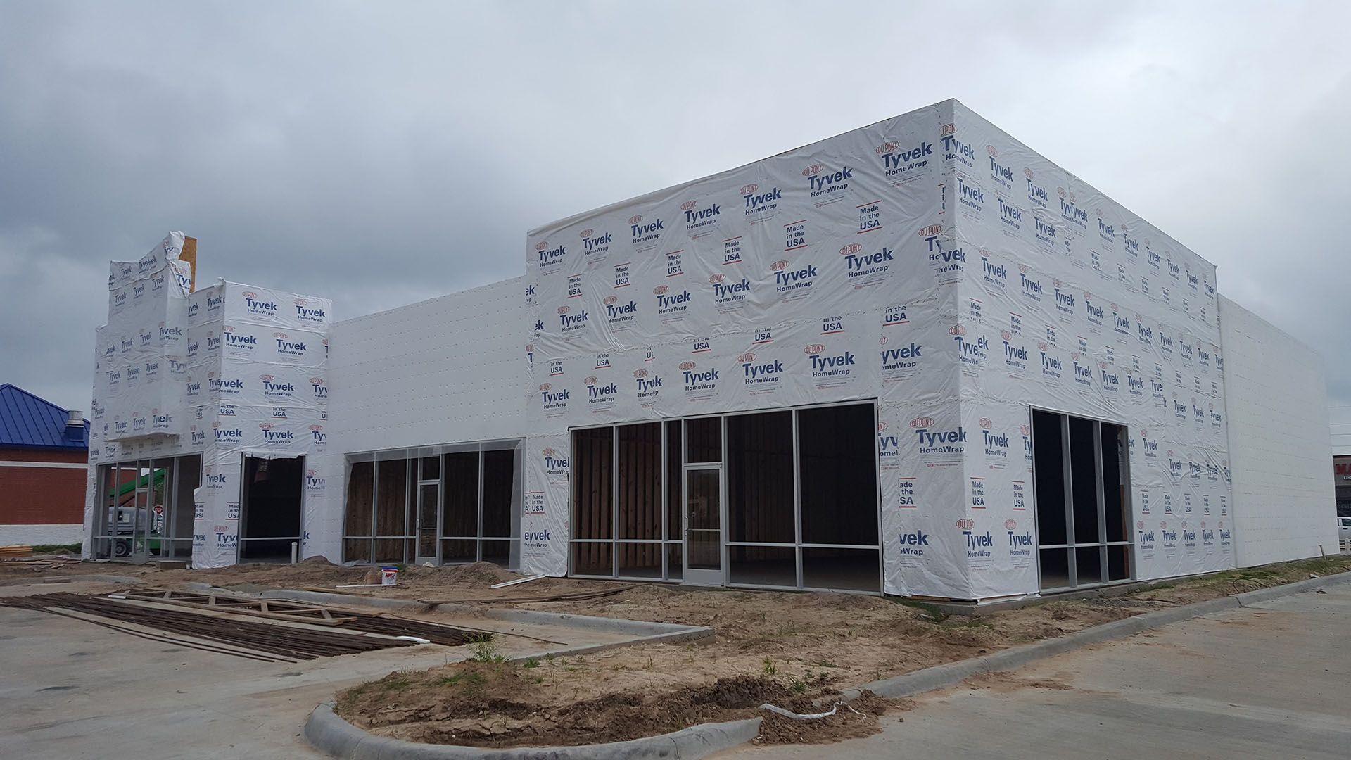A large building is being built on a cloudy day.