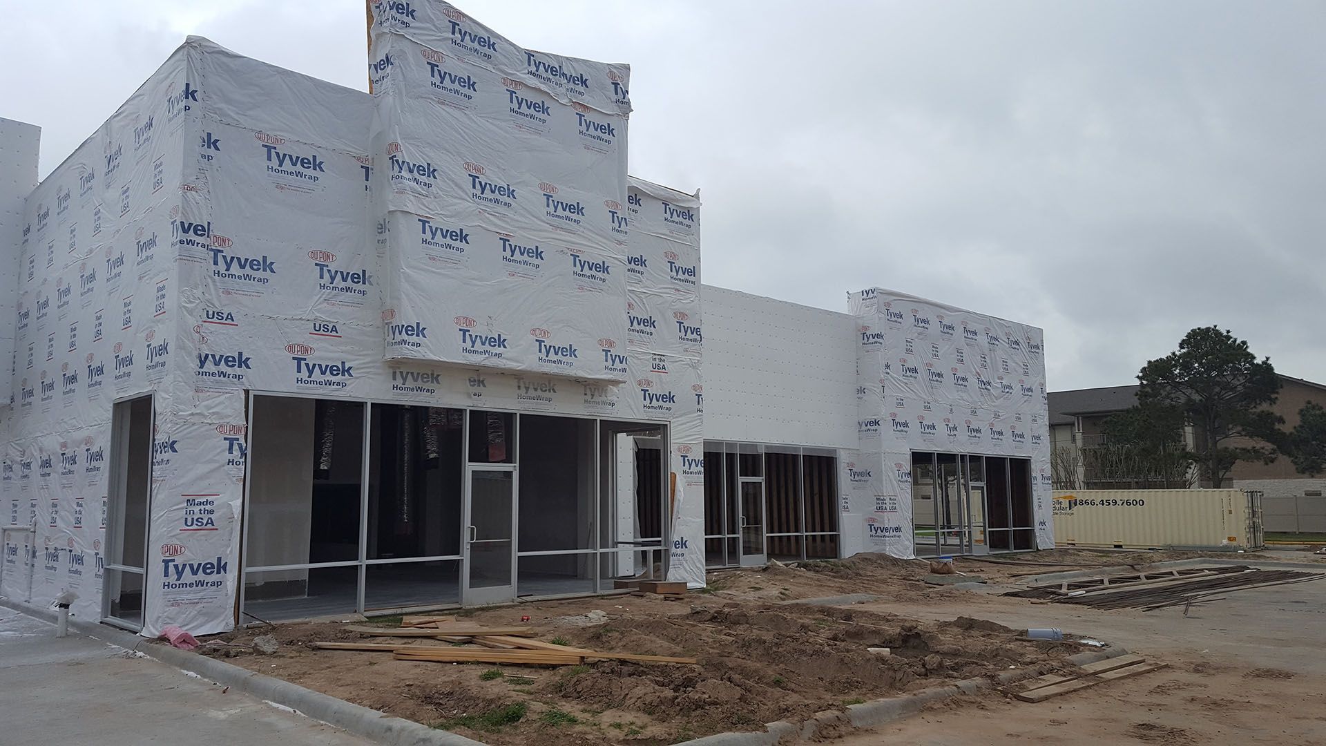 A building under construction with a lot of windows and a lot of concrete.