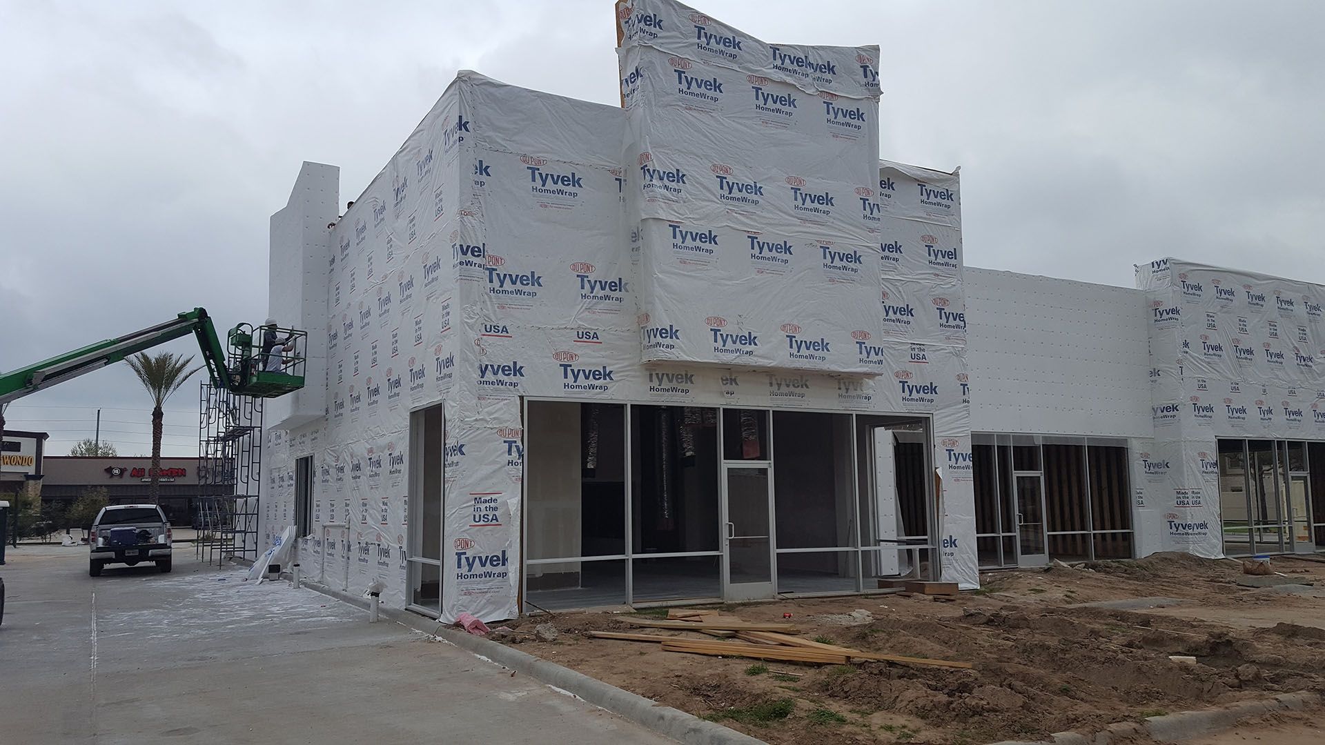 A large white building is being built with a lot of windows.