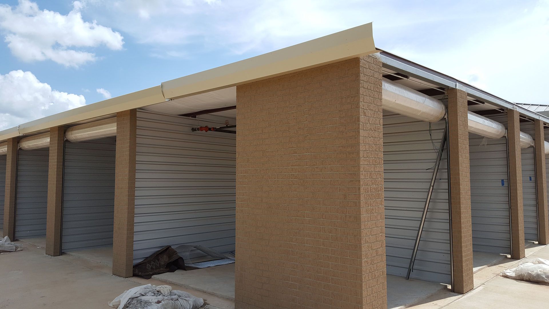 A building with a lot of columns and a roof is being built.