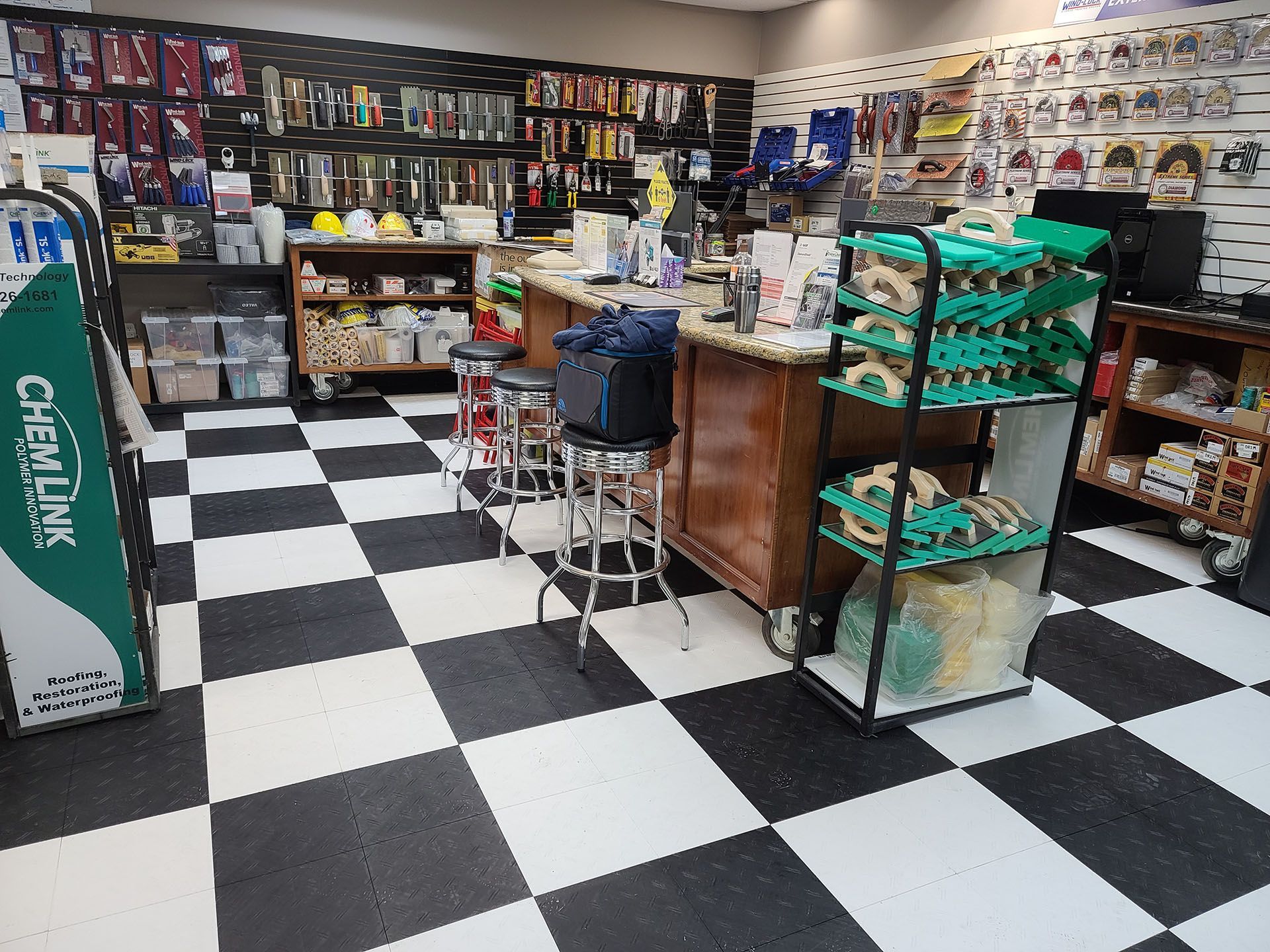 The inside of a hardware store with a checkered floor.