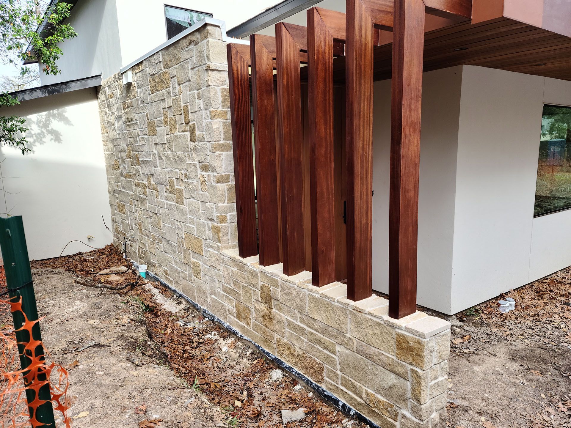 A white house with a wooden fence surrounding it