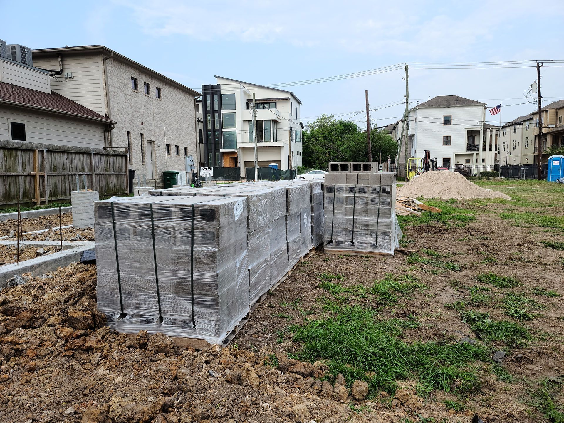 A stack of concrete blocks sitting on top of a dirt field.