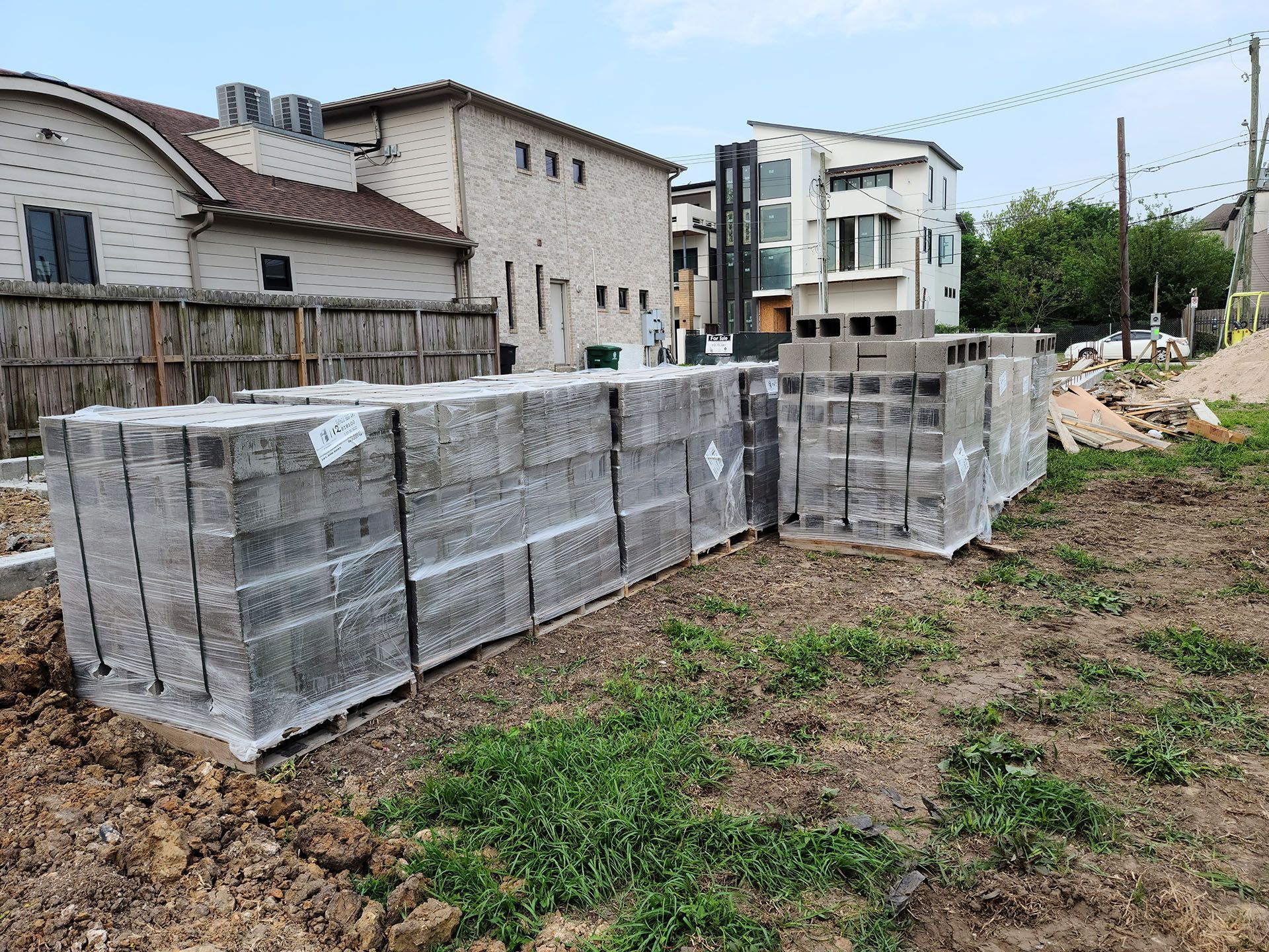 A pile of concrete blocks sitting on top of a dirt field.