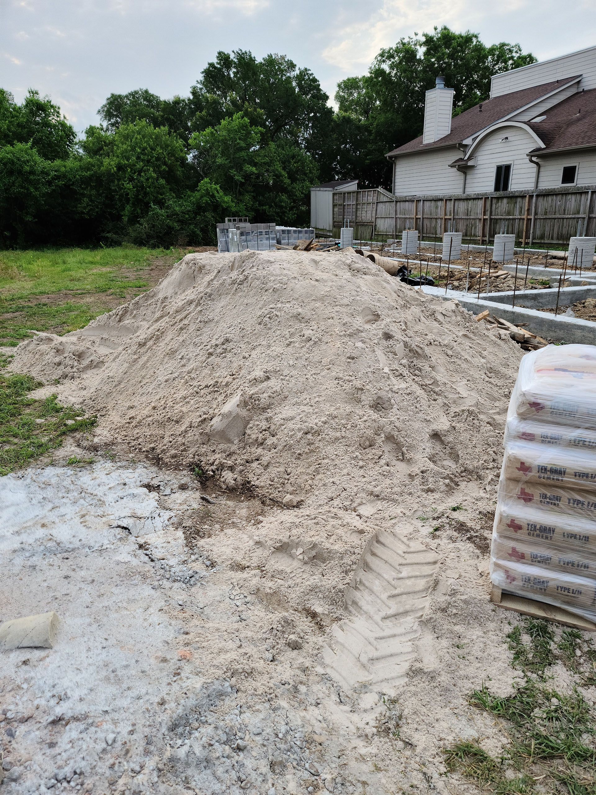 There is a pile of dirt in the middle of a field.