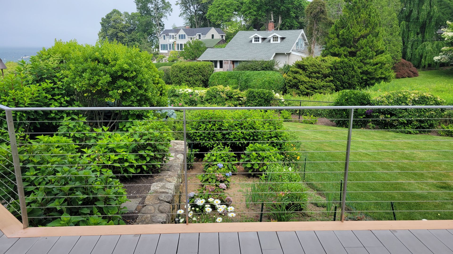 A view of a house and a garden from a balcony.