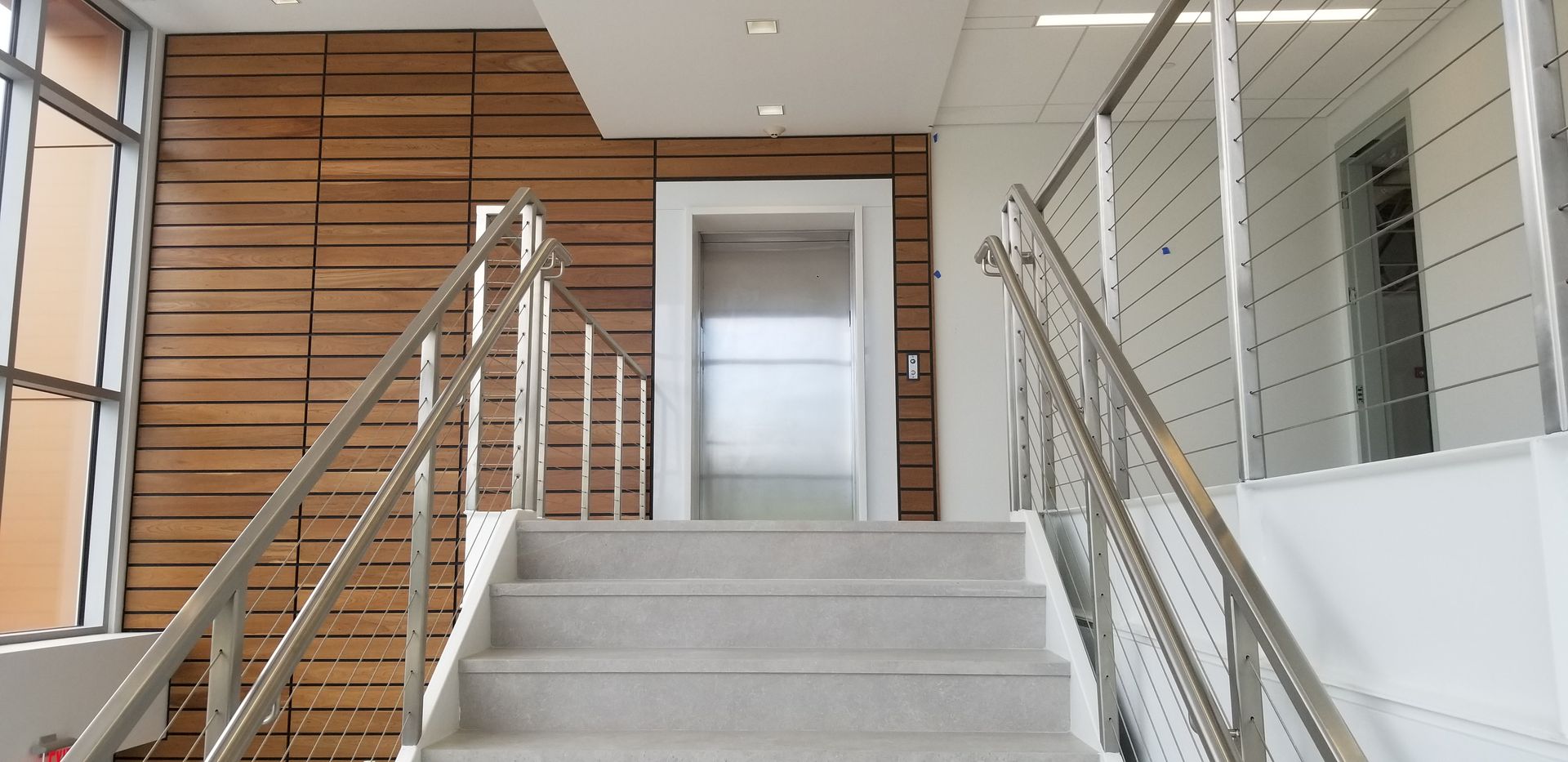 A staircase leading up to an elevator in a building
