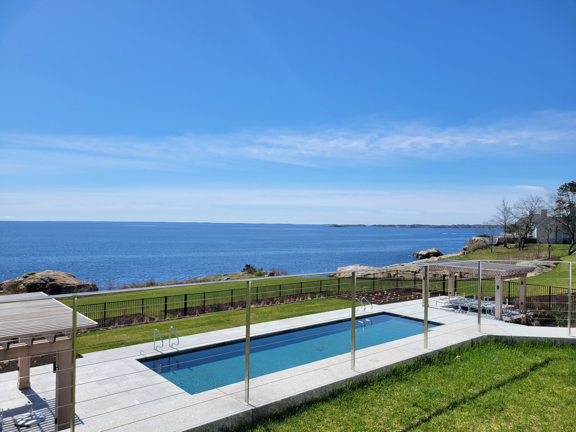 A large swimming pool with a view of the ocean.