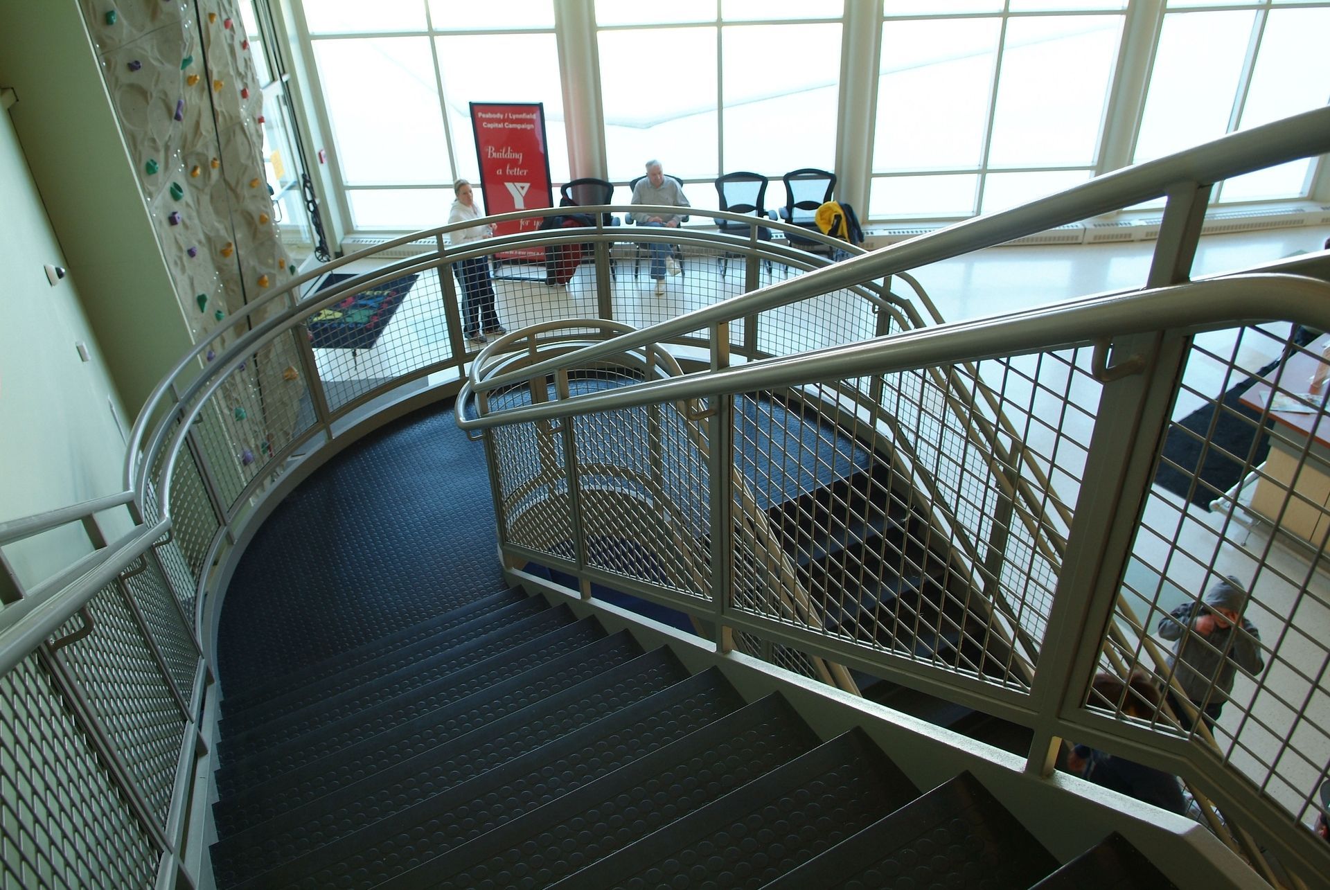 A spiral staircase with a metal railing in a building