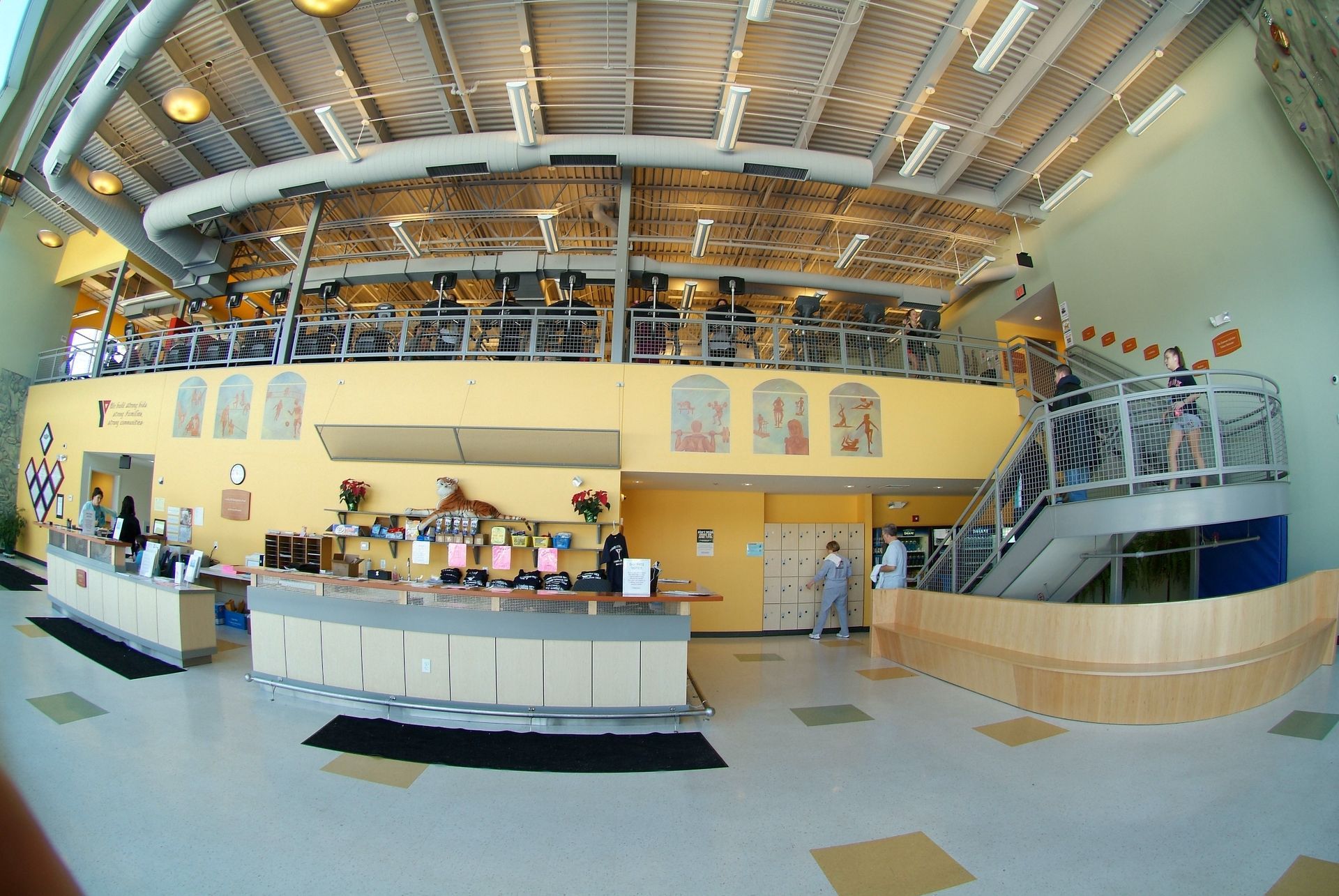 A large gym with a staircase leading up to the second floor