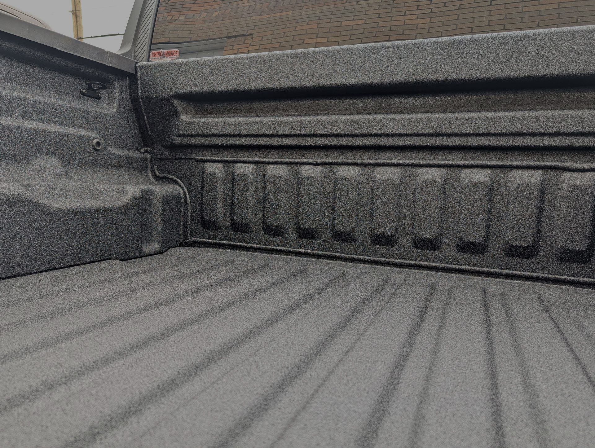 Textured truck bed interior with ribbed side panel