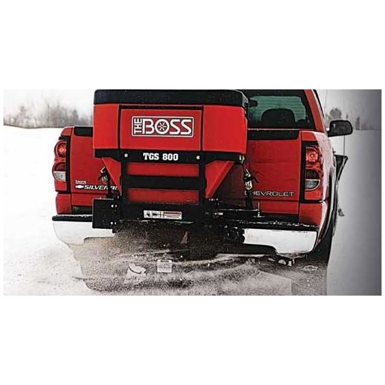 Red truck with BOSS salt spreader, in snowy setting.