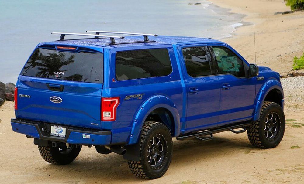 Blue Ford pickup truck with camper shell