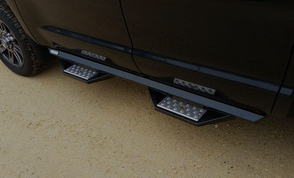 Black truck with black running boards and two silver steps