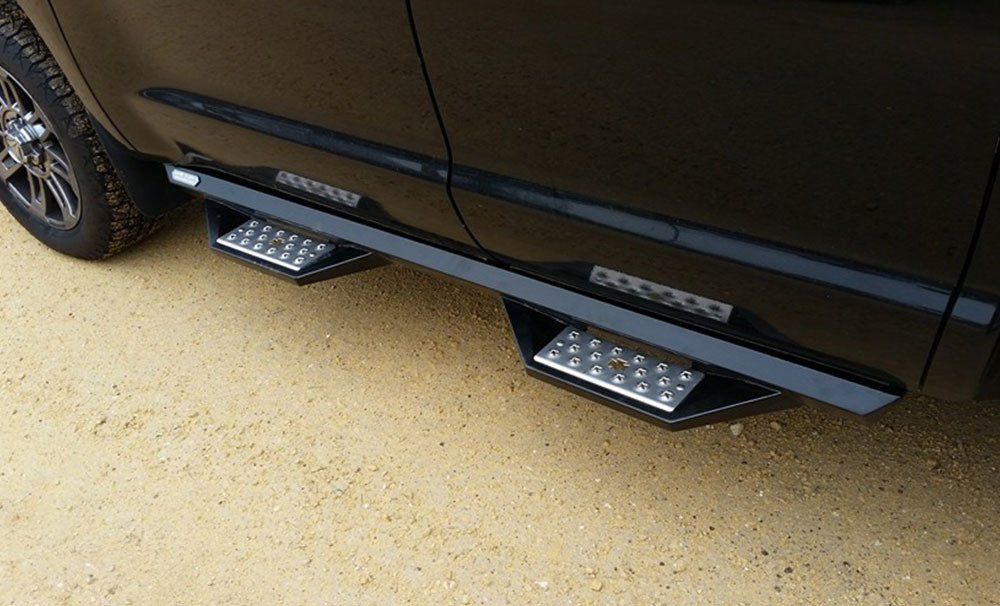 Black truck with black running boards and two silver steps