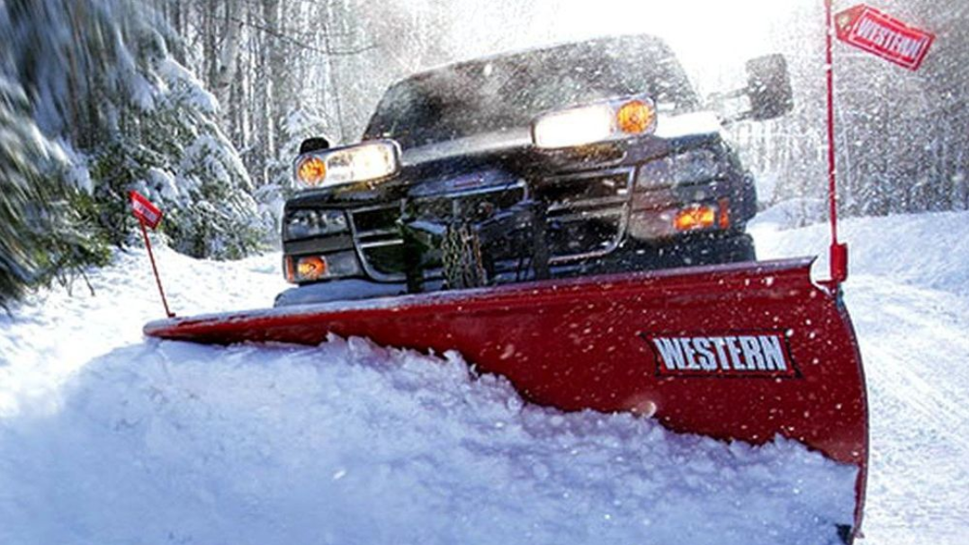 Learn More About Snowplows Snowplow truck plowing a snow-covered road