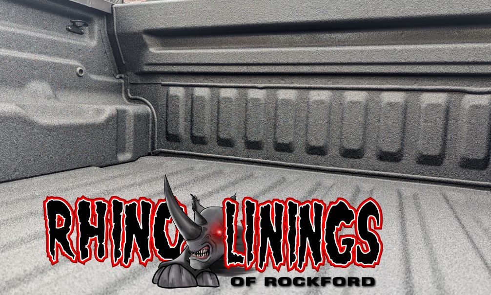 Rhino Linings truck bed with dark textured coating, company logo in foreground.