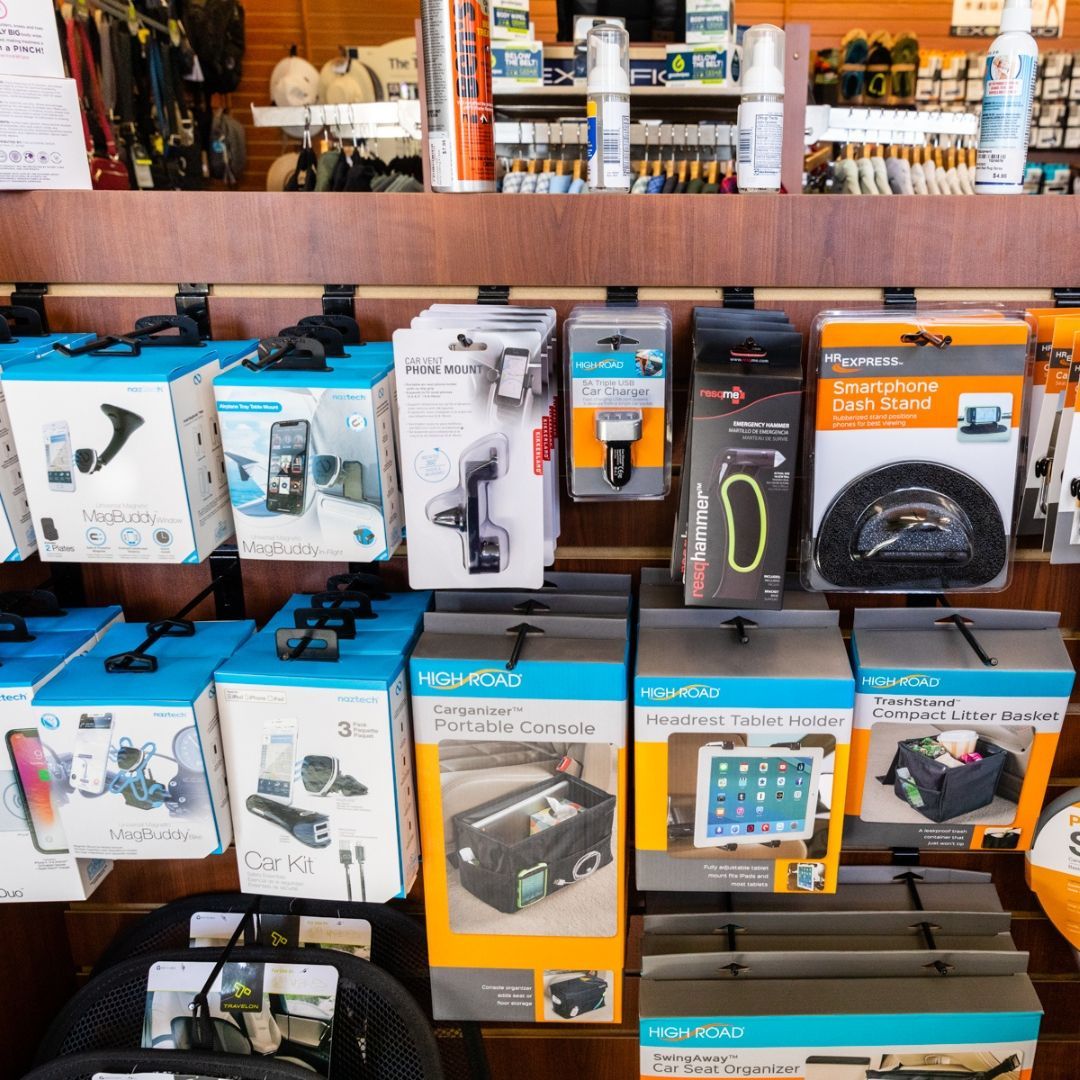 A store shelf displays various electronic accessories and car mounts in their retail packaging.