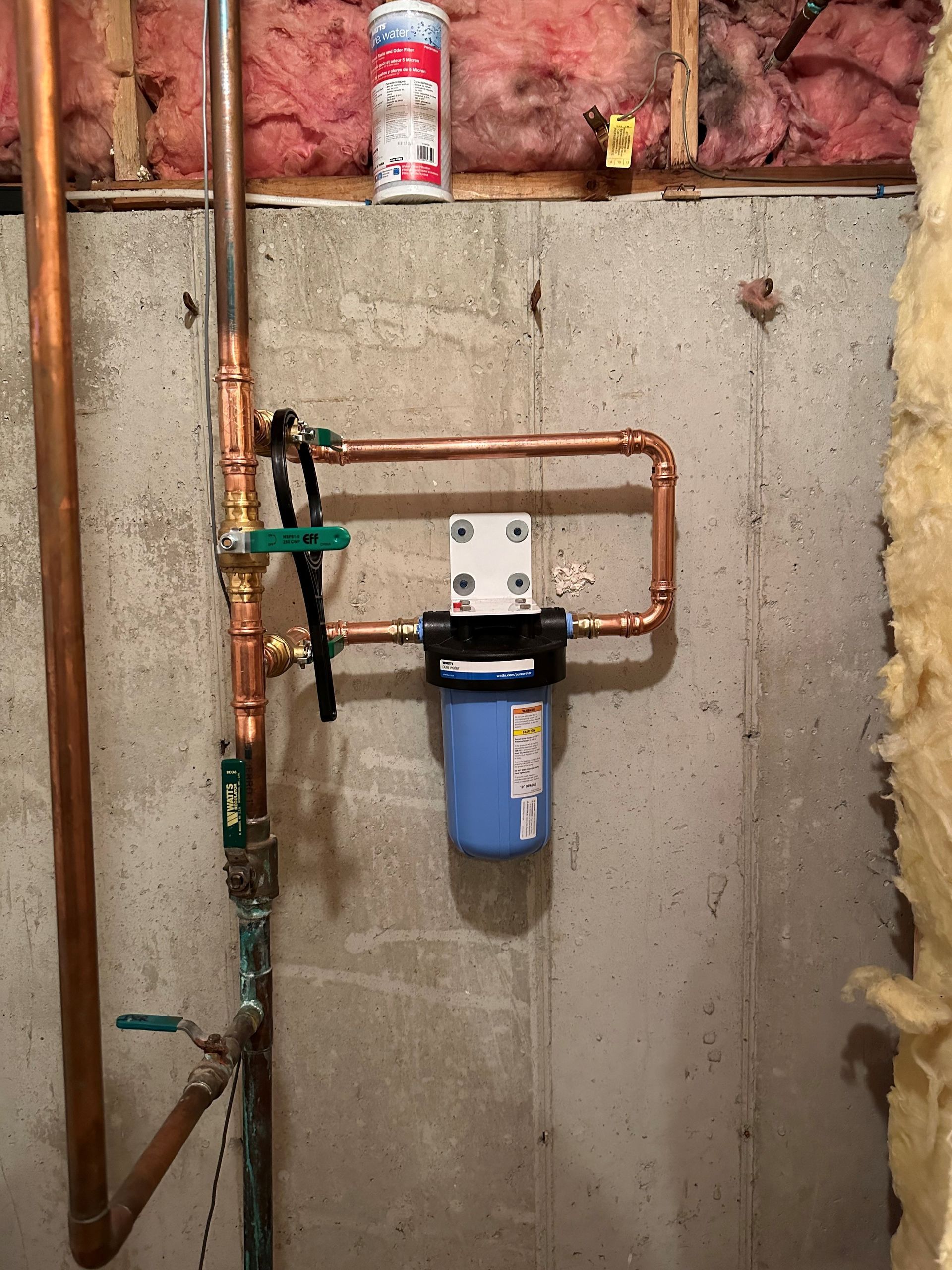 A copper pipe with a blue filter attached to it