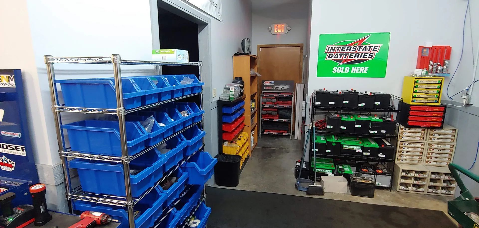 An interior shot of a parts storage room with shelves of bins and boxes of parts.
