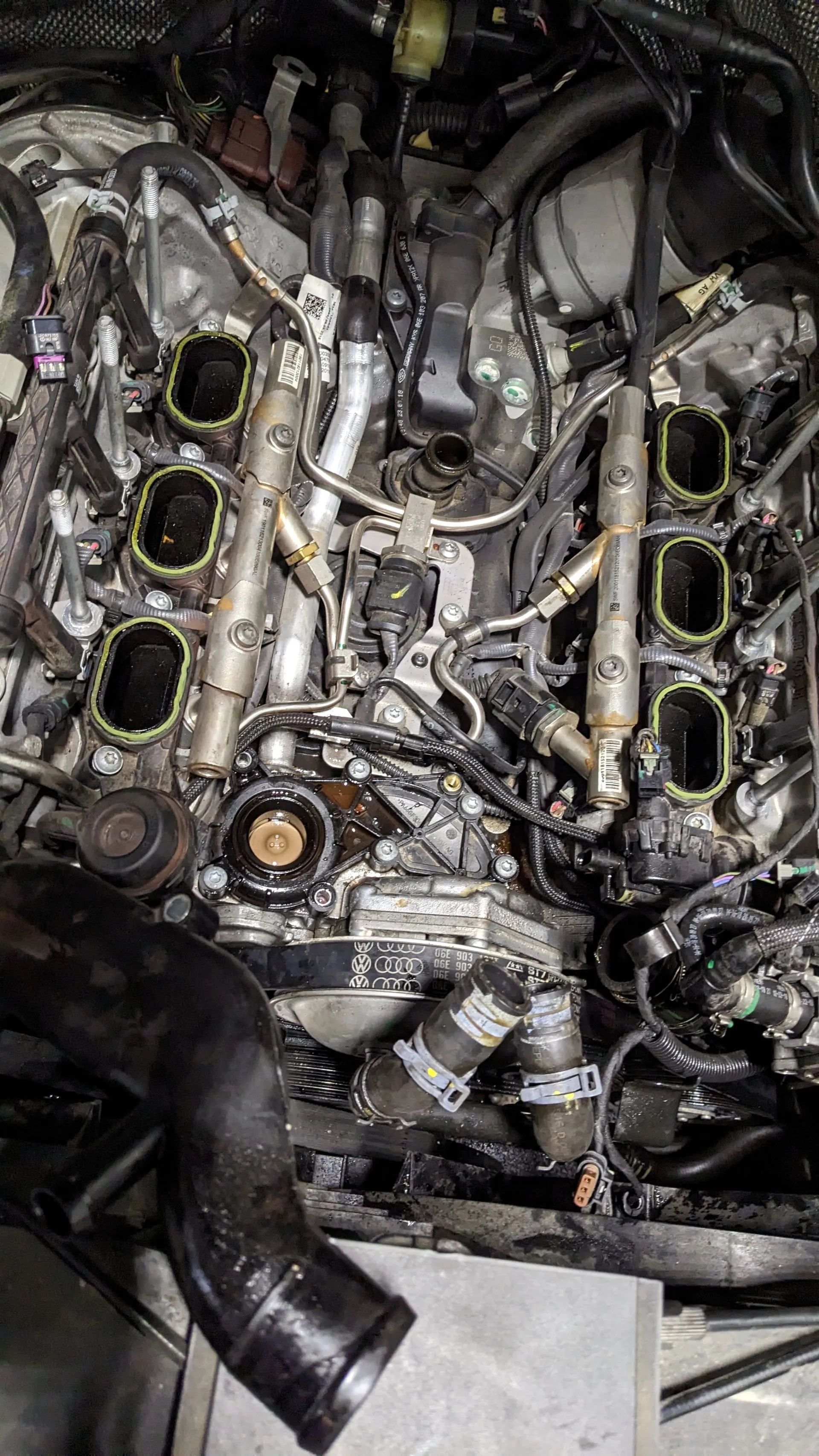 Engine bay with intake manifold removed, showing engine components and openings.