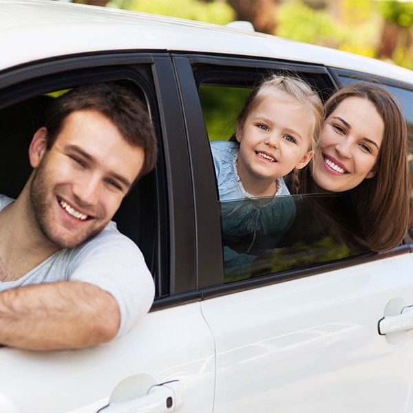 Happy family inside their car