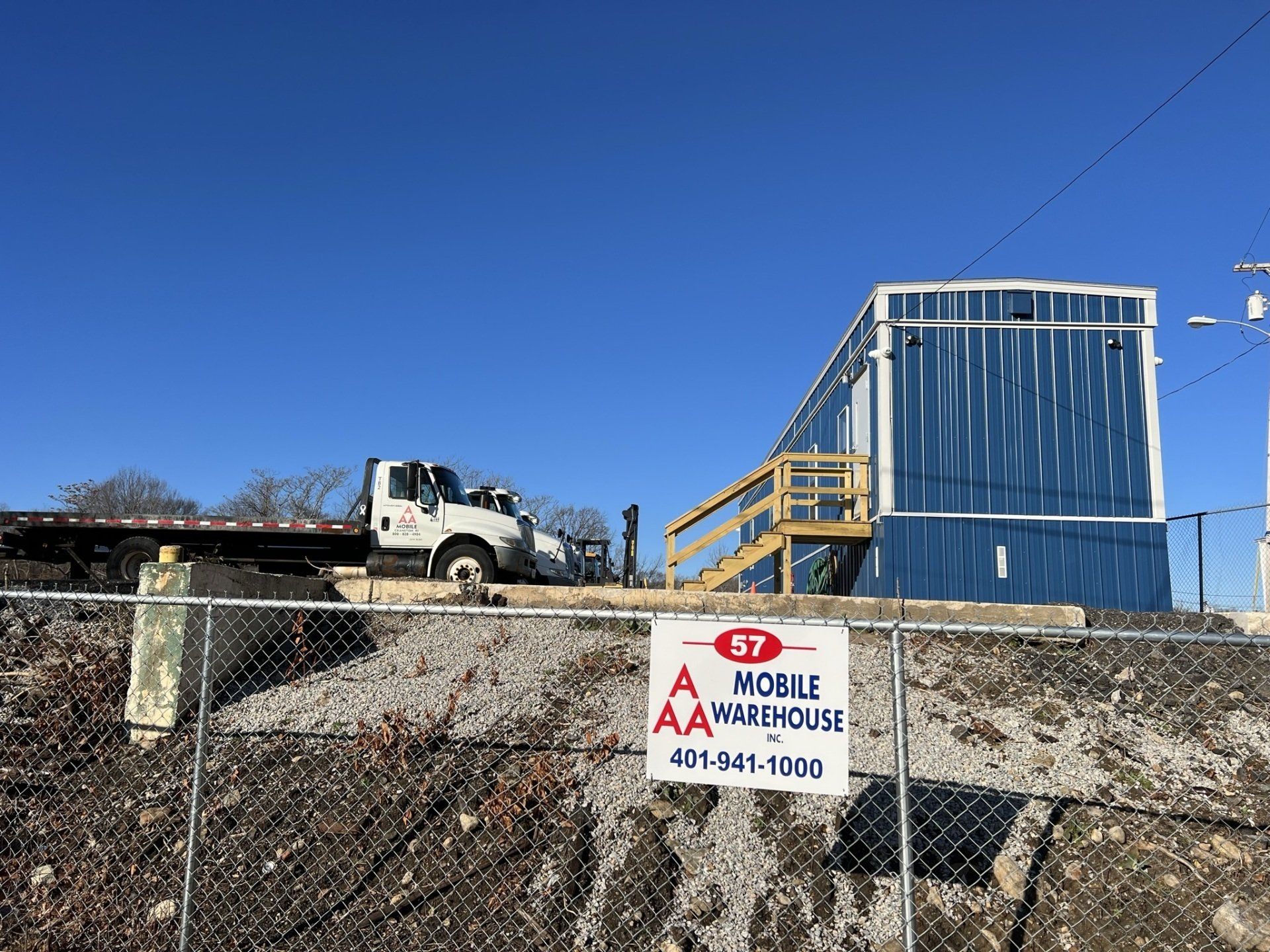 blue trailer showing a sign and a white truck