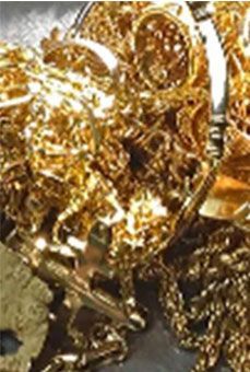 A pile of gold jewelry is sitting on a table.