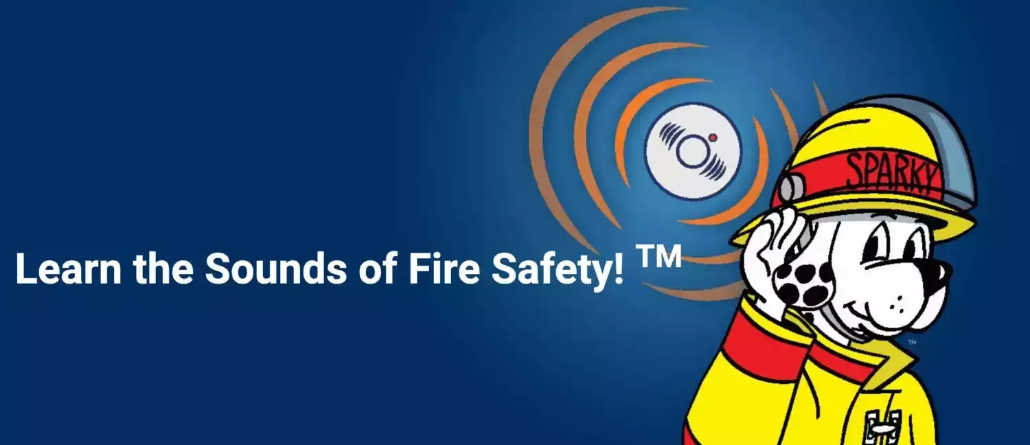 Fire safety banner with firefighter dog mascot and “Learn the Sounds of Fire Safety!” text