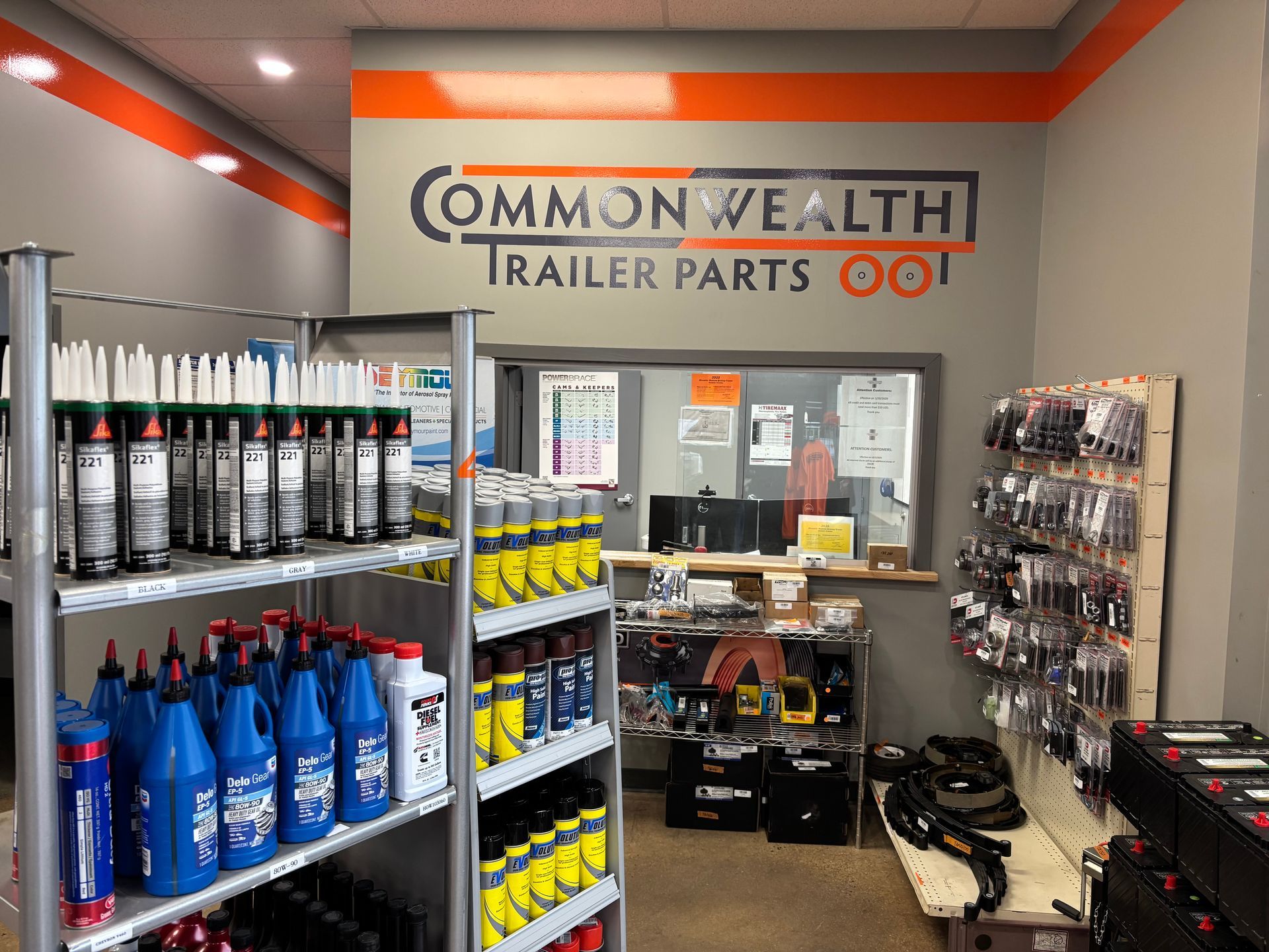 Interior of a store with shelves of fluids, tools, and hanging parts.