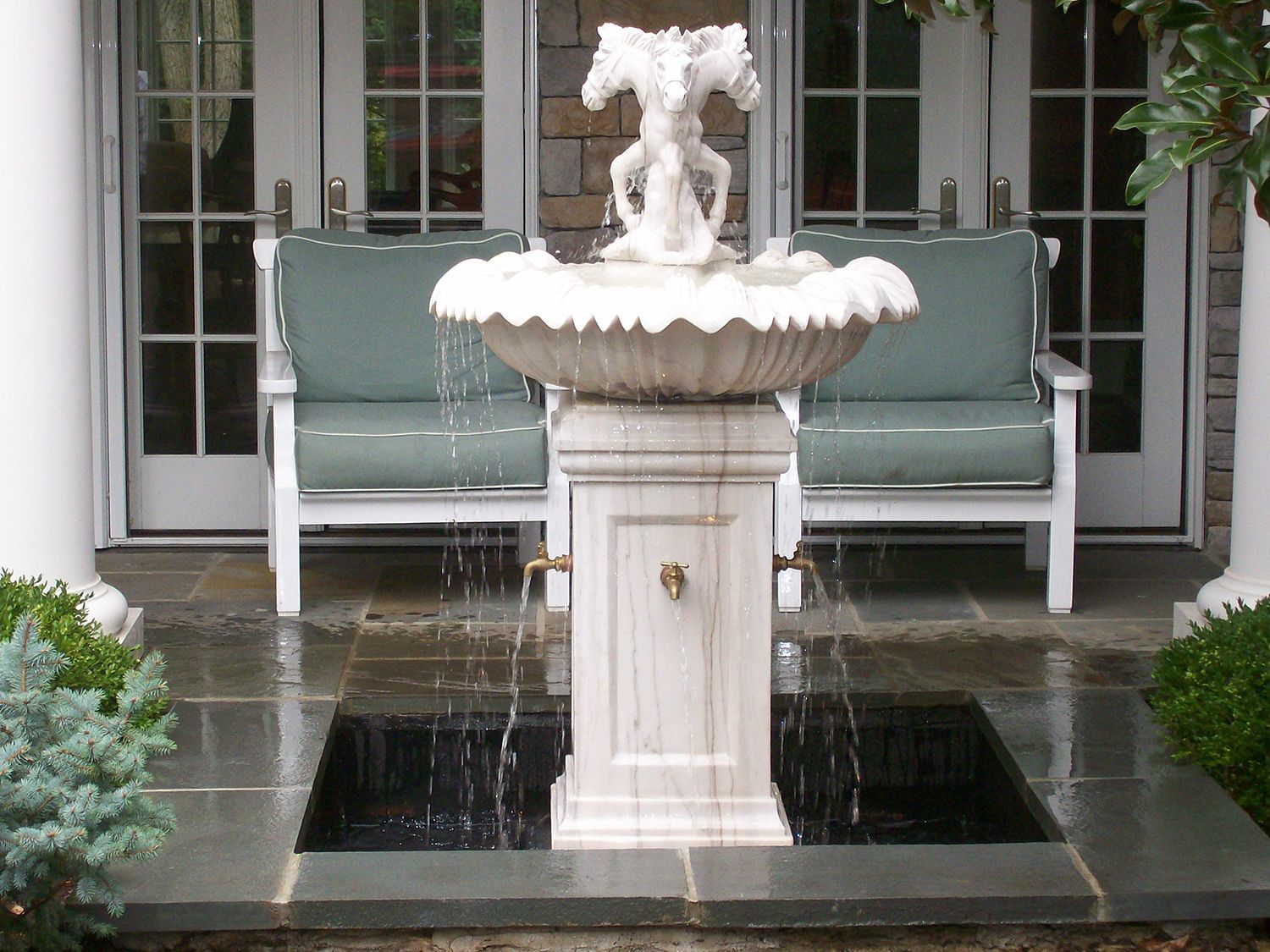 A fountain with a statue of a cherub on top of it