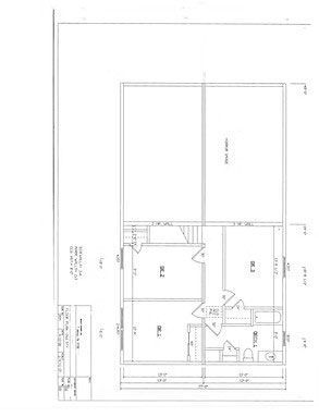 Architectural floor plan showing the layout of a residence with a deck, stairs, bedrooms, a bathroom, and living spaces.