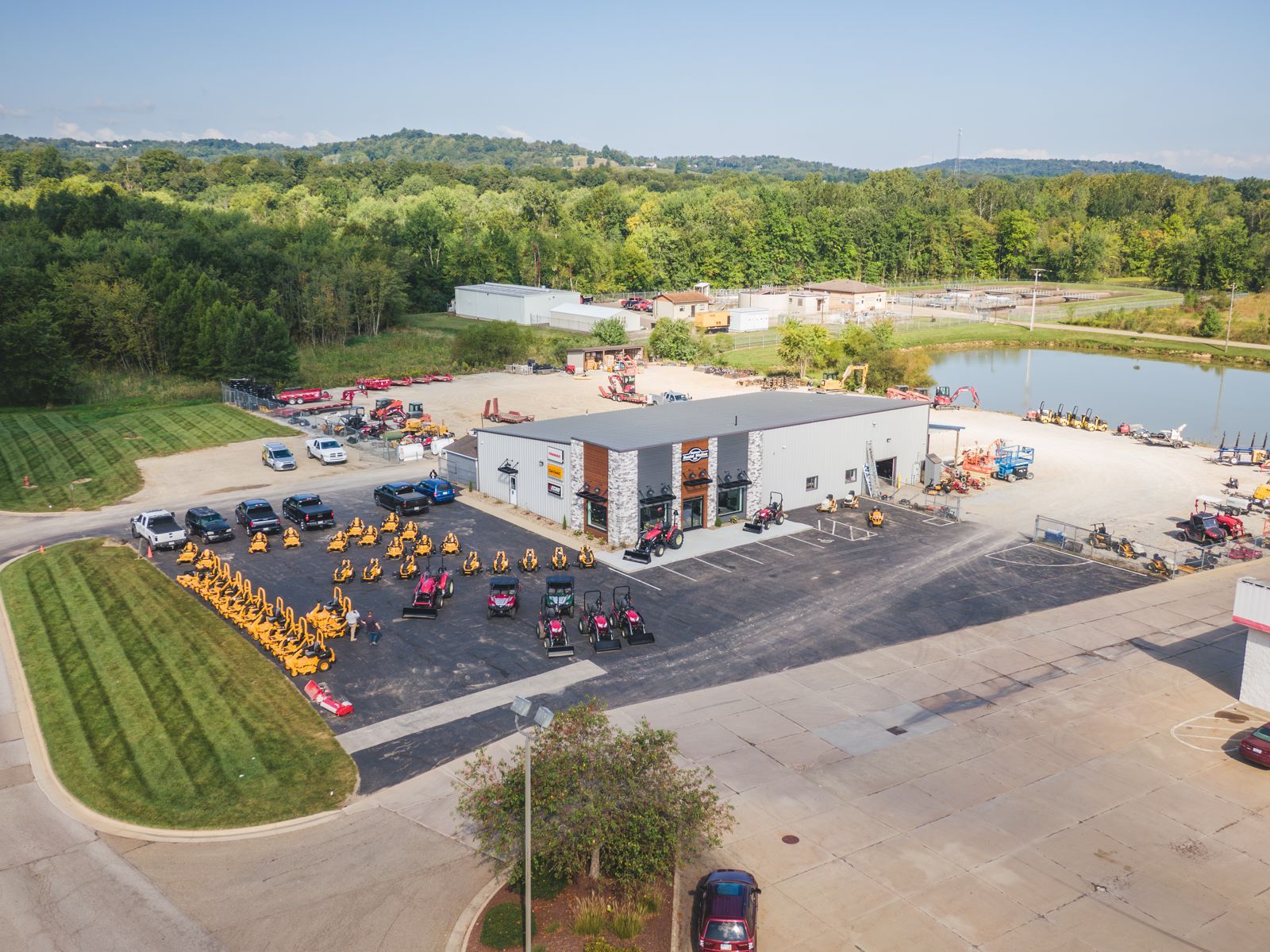 An aerial view of a large building with a lot of cars parked in front of it.