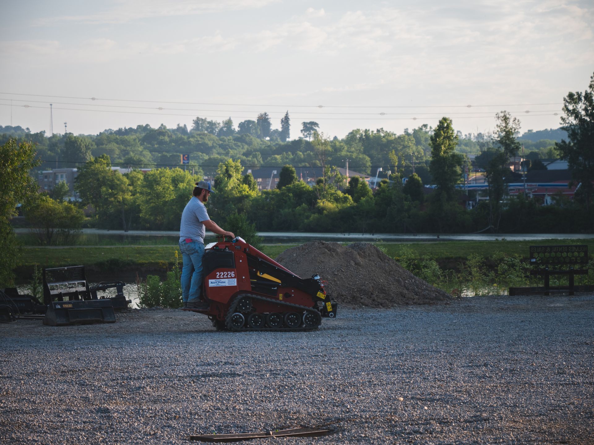 A man is using a machine to dig a hole in the ground.
