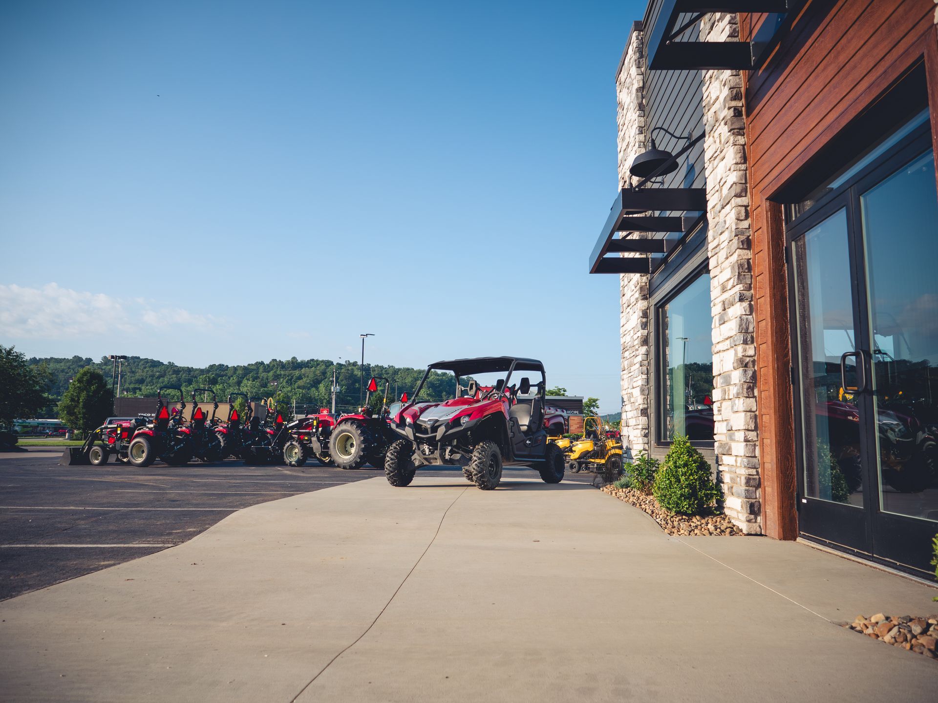 A red atv is parked in front of a building.