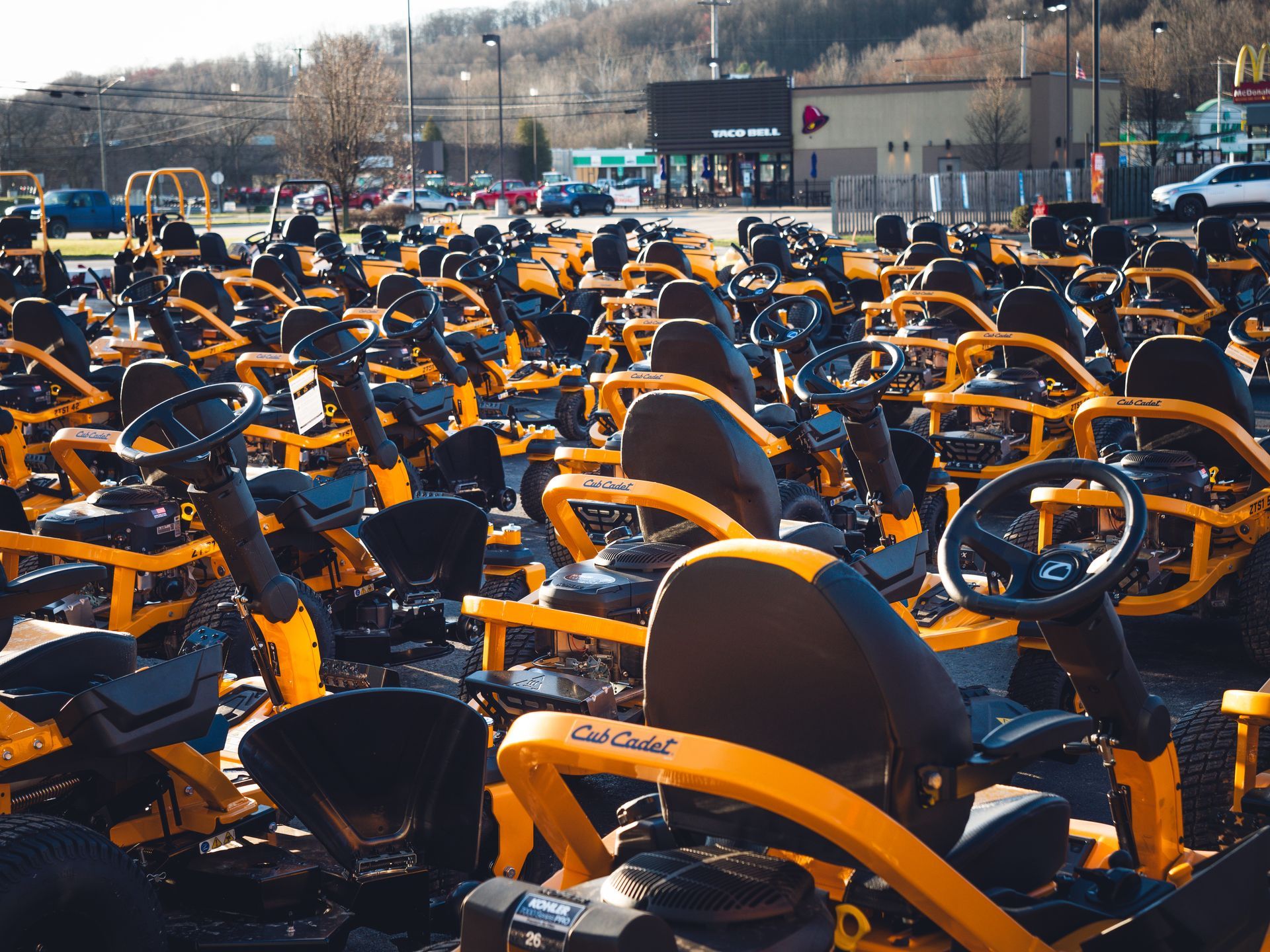 A bunch of go karts are parked in a parking lot