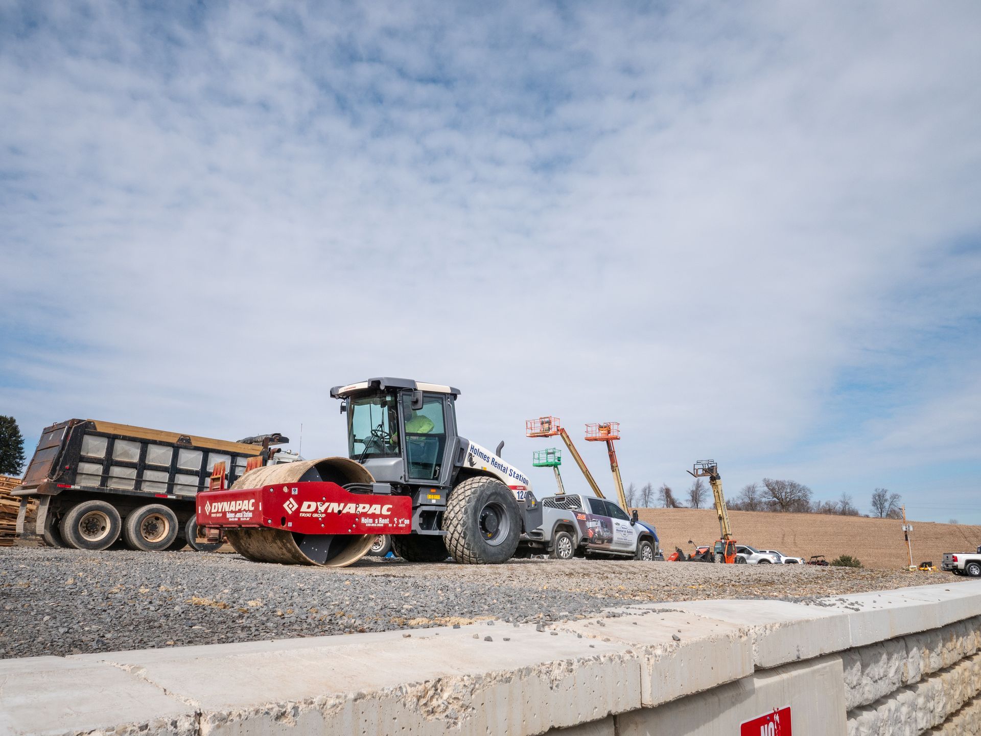 A construction site with a bulldozer and a dump truck.