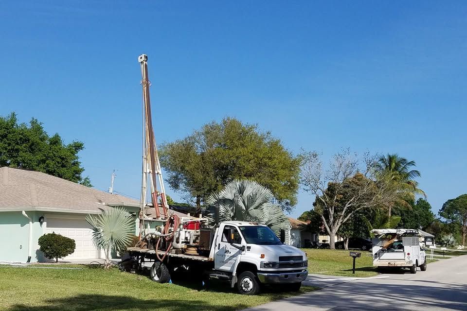 A truck is parked in the driveway of a house.
