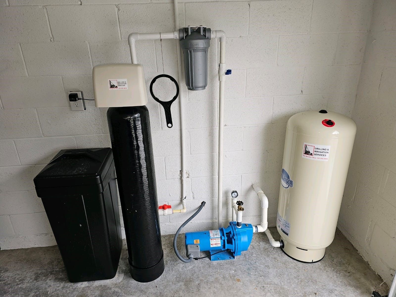 A row of blue water tanks are lined up in a room.