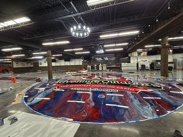 Large open store floor; colorful epoxy circle floor art; red, white, and blue; 