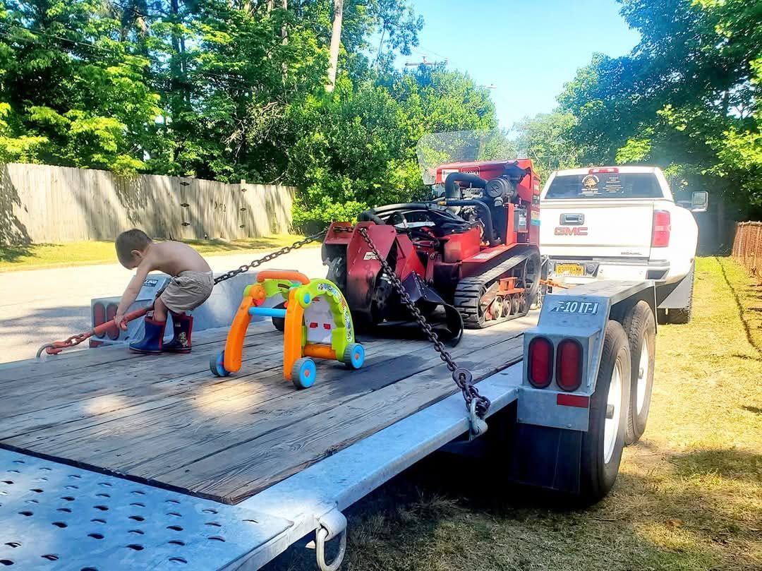 A boy is playing with a toy on the back of a trailer.