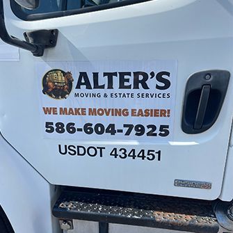 White moving truck door with Alter’s Moving & Estate Services logo, phone number, and USDOT number.
