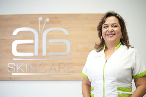A woman is standing in front of a sign that says skincare