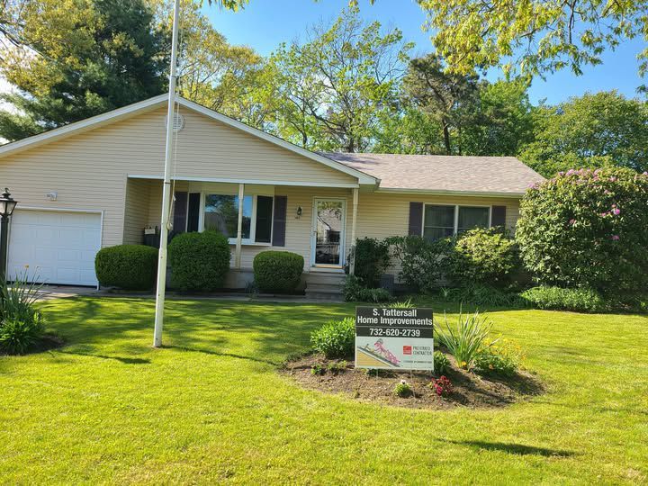 A house with a for sale sign in front of it