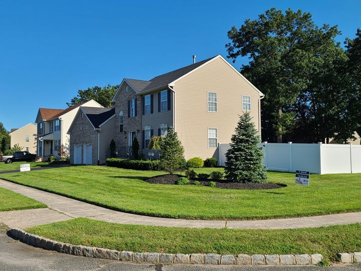 A house with a white fence in front of it